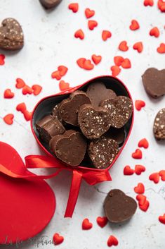 chocolate hearts in a heart shaped box on a table