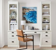 a white desk with a chair next to it and a painting on the wall behind it