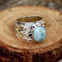 Natural Larimar Ring Wide Band Two Tone Ring Hammered Ring Sterling Silver Ring for Women Dominican Republic Larimar Blue Stone Worry RingMain Stone :Natural LarimarMain Stone Color : Blue  Main Stone Creation : Natural GemstoneMetal : Sterling SilverBase Metal : 925 parts per 1000Style : RingMetal Purity : 925 parts per 1000*SAjewellersStore is the desire and happiness for jewellery designers and makers. Beautiful, intricate and unique design jewellery making supplies. Each piece is a beauty to Adjustable Blue Larimar Ring, Elegant Blue Larimar Turquoise Ring, Blue Larimar Round Rings, Elegant Blue Larimar Rings, Blue Larimar Opal Ring, Bohemian Blue Birthstone Ring, Bohemian Blue Opal Ring For Anniversary, Blue Larimar Jewelry For Anniversary, Blue Larimar Moonstone Ring