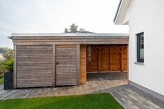 an outside view of a house with two garages on the side and one door open