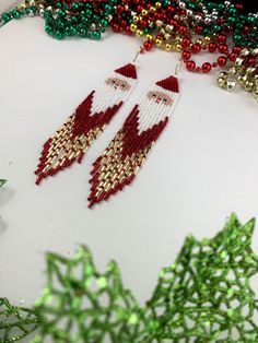 "Santa shoulder duster earrings, long Christmas beaded earrings, fringe earrings Length is 5 1/2\" including ear wire Width 1\" Made with Japanese seed beads Fun earrings for Christmas with gold color bugle beads Select closure leverbacks earwires clip-ons for non pierced ears" Christmas Dangle Beaded Earrings With Colorful Beads, Christmas Colorful Beaded Dangle Earrings, Red Bohemian Earrings For Christmas, Bohemian Jewelry For Christmas Holiday, Bohemian Jewelry For Christmas, Bohemian Christmas Holiday Jewelry, Christmas Red Beaded Earrings With Colorful Beads, Christmas Beaded Earrings As Gift, Beaded Dangle Christmas Jewelry