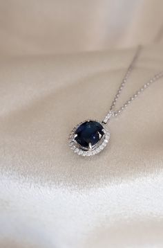 Blue Sapphire Oval Cut Pendant with a Diamond Halo. Pendant is by Diamond and Gold Warehouse in Dallas, Texas. Formal Blue Oval Diamond Necklace, Blue Diamond Necklace For Formal Occasions, Luxury Blue Diamond Necklace For Formal Occasions, Formal Sapphire Necklace Fine Jewelry, Formal Sapphire Pendant Diamond Necklace, Luxury Blue Diamond Cut Necklace, Formal Round Sapphire Necklaces, Luxury Blue Diamond Necklace, Exquisite Sapphire Diamond Necklace