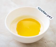 an egg yolk in a white bowl with a name tag