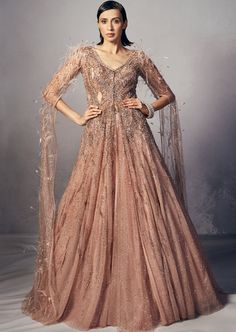 Heavily embellished rouge shimmer tulle jacket paired with tulle lehenga accentuated with long cape sleeves sprinkled with feathers and crystals. Lehenga With Cape, Tulle Lehenga, Jacket Lehenga, Tulle Jacket, Rahul Khanna, Long Cape, Payal Singhal, Potli Bags, Cape Sleeves