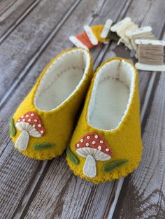 a pair of yellow shoes sitting on top of a wooden floor