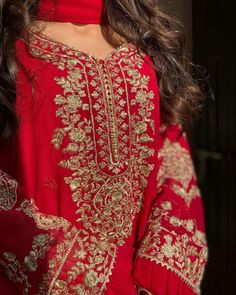 a woman wearing a red and gold outfit