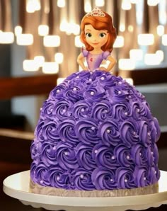 there is a cake that looks like a princess sitting on top of the purple cake