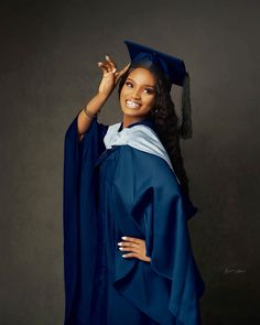 a woman wearing a blue graduation gown and cap