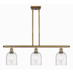 three light pendant fixture with clear glass shades on an aged brass metal track lighting fixture