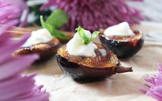 some food is sitting on a table with purple flowers in the backgroung