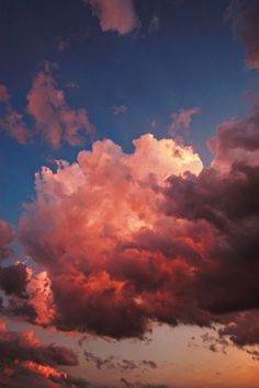 the sky is filled with pink clouds as the sun sets