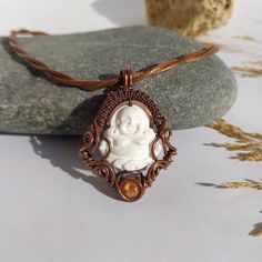 This handcrafted and hand carved Buffalo Bone Buddha Pendant with Sunstone and copper wire wrapping is a unique and spiritual piece of jewelry. It has a mystical aura, making it a perfect gift for those who value spirituality and meditation. Ideal gift for: - Spiritual and Meditation Enthusiasts: This pendant is a wonderful gift for individuals who are deeply connected to their spiritual practice or who enjoy meditative activities. The Buddha symbol and Sunstone can enhance their experience, pro Spiritual White Jewelry For Gifts, Spiritual White Jewelry As A Gift, Spiritual White Wire Wrapped Jewelry, Handmade White Jewelry For Meditation, White Spiritual Wire Wrapped Jewelry, Wire Wrapped Pendant Necklace For Meditation, Spiritual Bronze Wire Wrapped Necklace, Bronze Wire Wrapped Spiritual Necklace, Meditation Amulet Pendant Jewelry