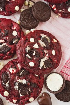 cookies and oreos are on the table with chocolates around them, including marshmallows