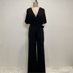 This Short Sleeve Jumpsuit Made With Stretchy Fabric Will Make You Feel Comfortable For A Night Out Or At A Wedding. There Is Also Waist Loops For A Sash Or You Can Replace It With A Belt. Size S, Runs Big. New Without Tags. Elegant Solid Color Jumpsuits And Rompers For Going Out, Elegant Jumpsuits And Rompers For Night Out, Elegant Black Jumpsuits And Rompers For Night Out, Elegant Black Jumpsuit For Night Out, Elegant Black Bodysuit For Date Night, Elegant Spring Loungewear Bodysuit, Elegant Bodysuit For Spring Loungewear, Elegant Spring Bodysuit For Loungewear, Elegant Black Jumpsuit For Going Out