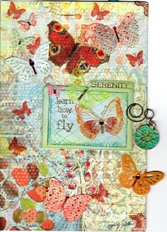 an altered book with butterflies on it and a keychain hanging from the cover