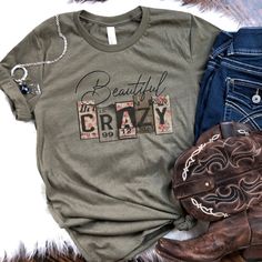 Our Beautiful Crazy Tee is the perfect shirt to wear any day to your next country concert, rodeo or just out on the town with all your crazy girlfriends! Also makes a great friend gift for all your country loving friends any time of the year! Our tees are sublimated on super soft unisex t-shirts. If you are looking for soft, comfortable and high quality tees, you are in the right shop! Pair perfectly with shorts, jeans and your favorite pair of boots and wear to your next rodeo or concert or a p Fall Letter Print T-shirt For Country Concerts, Graphic Tee With Letter Print For Country Festivals, Cotton T-shirt With Letter Print For Country Festivals, Trendy Crew Neck Tops For Country Concerts, Trendy Tops For Country Concerts In Spring, Trendy Tops For Spring Country Concerts, Spring Crew Neck T-shirt For Country Concerts, Relaxed Fit Cotton T-shirt For Country Festivals, Relaxed Cotton T-shirt For Country Festivals