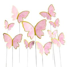 pink and gold butterfly picks on white sticks with the top cut out to look like they are