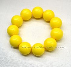 jewelry: yellow beaded bracelet - Big yellow beaded bracelet - women bracelet - gift for him - gift for her bead material: Acrylic Diameter: 20mm Shape : round Luster: High body: clean Necklace length: choose colour: yellow Packing:Beautiful Pouch If you want to order of different style. Please feel free contact me . Thank you . Matching necklace: https://www.etsy.com/listing/1456478133/big-yellow-beaded-necklace-24mm-yellow?click_key=e3a2d3a3ec69cf1654bc96ca7e2d2b2ec0985f4f%3A1456478133&click_s Yellow Beaded Stretch Bracelet With Round Beads, Yellow Beaded Stretch Bracelet, Yellow Stretch Bracelet With Round Beads As Gift, Yellow Beaded Stretch Bracelet As Gift, Yellow Stretch Bracelet Gift, Adjustable Yellow Stretch Bracelet With Round Beads, Adjustable Yellow Stretch Bracelet With Large Beads, Yellow Beaded Bracelet, Blue Costumes