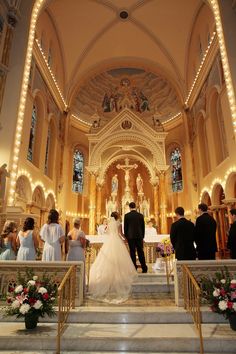 a bride and groom are walking down the aisle at their wedding ceremony in a church