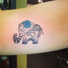 an elephant with a flower on it's head is shown in this tattoo design