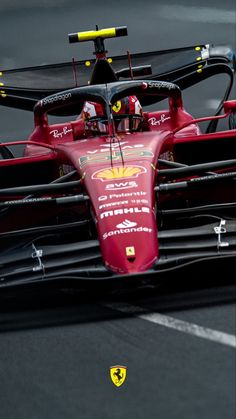 a red race car driving on a track