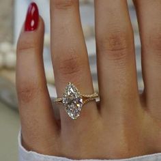 a woman's hand with a diamond ring on it