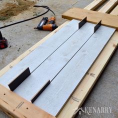 a wooden pallet with some tools on the ground