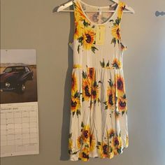 New Sunflower Dress With Tags. Size Medium Casual Sunflower Print Spring Dress, Casual Yellow Sunflower Print Dress, Casual Floral Print Midi Dress For Daytime, Spring Beach Dress With Sunflower Print, Spring Sundress With Sunflower Print, Casual Fitted Sunflower Print Dress, Sleeveless Sundress With Sunflower Print For Spring, Casual Fitted Dress With Sunflower Print, Casual Sunflower Print Beach Dress