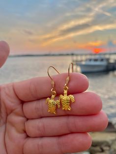 These gold ear wire sea turtle earrings are the absolute cutest accessory! 🐢 The wire on these earrings is 304 Stainless Steel that is gold plated. They measure 21x21x2.5mm🌊 The sea turtle charm is an alloy gold sea turtle pendant measuring 16x12.4x2.2mm☀️ Sea Turtle Jewelry, Shark Tooth Necklace, Turtle Jewelry, Tooth Necklace, Face Earrings, Turtle Charm, Turtle Earrings, Turtle Pendant, Earrings Photo