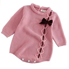 a pink sweater with a bow on the front