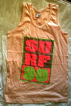 Up for purchase is a vintage tank top by Poly Tees Hawai`i, with printed "Surf 90" design.  The small print at the bottom of the design is '1989'. Color is kind of a Pink-ish shade and it is all cotton.  The size notation is 'S' -there is no gender notation but I have listed it as a Women's item because of the measurements.  It is @ 17 inches across the chest between the bottom of the armholes; length is @ 25 inches from the back-center collar to bottom front. Regardless of what the size on the 90s Inspired Logo Print Summer T-shirt, Retro Letter Print Tank Top, 90s Letter Print Tank Top For Streetwear, Vintage Tank Top For Spring Streetwear, 90s Style Screen Print Tops For Summer, Retro Graphic Print Tank Top For Summer, 90s Style Summer Tops With Screen Print, Vintage Logo Print Tops For Spring, Retro Graphic Print Tank Top For Streetwear