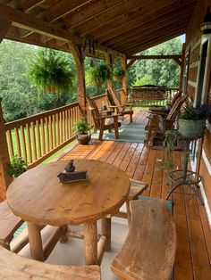 a wooden porch with chairs and table on it