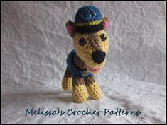 a crocheted stuffed animal wearing a blue hat