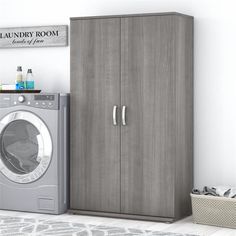 a laundry room with a washer and dryer in front of it, next to a cabinet