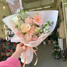 a person holding a bouquet of flowers in their hand