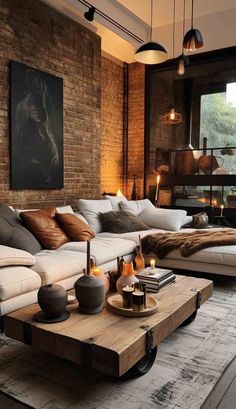 a living room filled with lots of furniture next to a brick wall and flooring