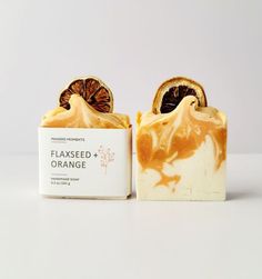 a soap bar with an orange slice on it and the top half cut open to show its contents