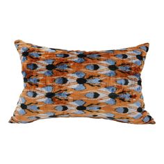 an orange and blue pillow on a white background