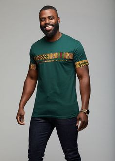 Style #: M2028GTB The Jaheem African Print Short Sleeve Tee (Green Tortoise Back) elevates your casual wear, creating a more sophisticated ensemble for the refined gentleman. As a transitional piece, sport the tee with a pair of jeans or dress pants. Take advantage of this multipurpose piece, as it is what your wardrobe's been missing! Description: • Comfortable and soft cotton t-shirt • Double strip applique on front and single strip applique on sleeves.• Made in USACare Instruction:Machine was African T Shirts Design, Modern African Clothing, African Print Shirt, African Print Tops, African Dresses Men, African Shirts For Men, African Print Clothing, African Clothing For Men, African Shirts