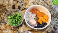 a bowl filled with rice, peas and carrots next to a small glass container