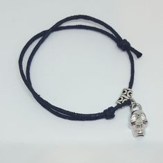 "Skull Bracelet/ Macrame Bracelet/Cord Bracelet/Adjustable Bracelet/Faux Suede Cord Bracelet/ Black Bracelet/Gift for Him or Her Faux leather knotted skull bracelet. The bracelet is faux leather cord with skull connector charm. The charm is quarter sized at about 1/2\" in diameter, and is displayed on a silver bail. The ends of all knots are glued with jewelry glue to insure quality as well. The bracelet will easily fit a wrist from 6\" to 9\" with ease in that it is adjustable and easy to wear! Adjustable Skull Leather Bracelet For Gifts, Adjustable Skull Leather Bracelet Gift, Adjustable Silver Leather Bracelet With Sliding Knot, Adjustable Skull Bracelet As Gift, Adjustable Skull Bracelets As Gift, Adjustable Sliding Knot Leather Bracelet, Adjustable Handmade Skull Bracelets, Adjustable Nickel-free Bracelets With Waxed Cord, Adjustable Black Leather Bracelet With Sliding Knot