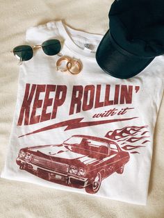 Keep Rollin! Our newest collection of graphic tees! With distressed, vintage style prints, these are your new go-to wardrobe staple. #graphictee #vintagetshirt #graphictshirt Vintage Tops With Graphic Print For Retro-themed Events, Retro T-shirt With Sublimation Print, Relaxed Fit, Retro Relaxed Fit T-shirt With Sublimation Print, Vintage Print Graphic Tee For Fans, Graphic Tee With Vintage Print For Fans, Fan Merchandise Graphic Tee With Vintage Print, Trendy Vintage Print T-shirt For Streetwear, Relaxed Fit Graphic Tee With Vintage Print, 50th Clothes