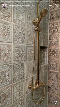 the shower head and hand held shower faucet are in front of a tiled wall