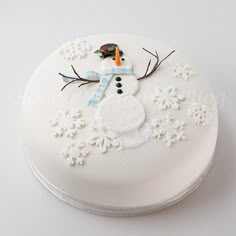 a white cake with a frosting snowman on it