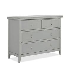 a grey dresser with three drawers and two doors on the bottom drawer, in front of a white background