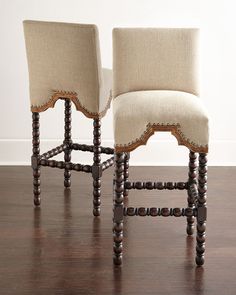 two chairs sitting side by side on top of a hard wood floor