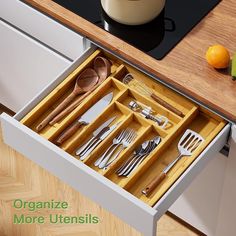 an organized drawer with utensils in it