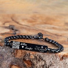 a black bracelet with a message on it that says i love you to the moon and back