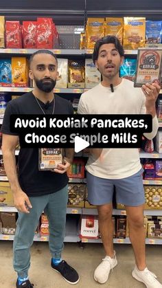 two men standing next to each other in front of shelves with food items on them