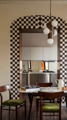 a dining room with checkered walls and chairs